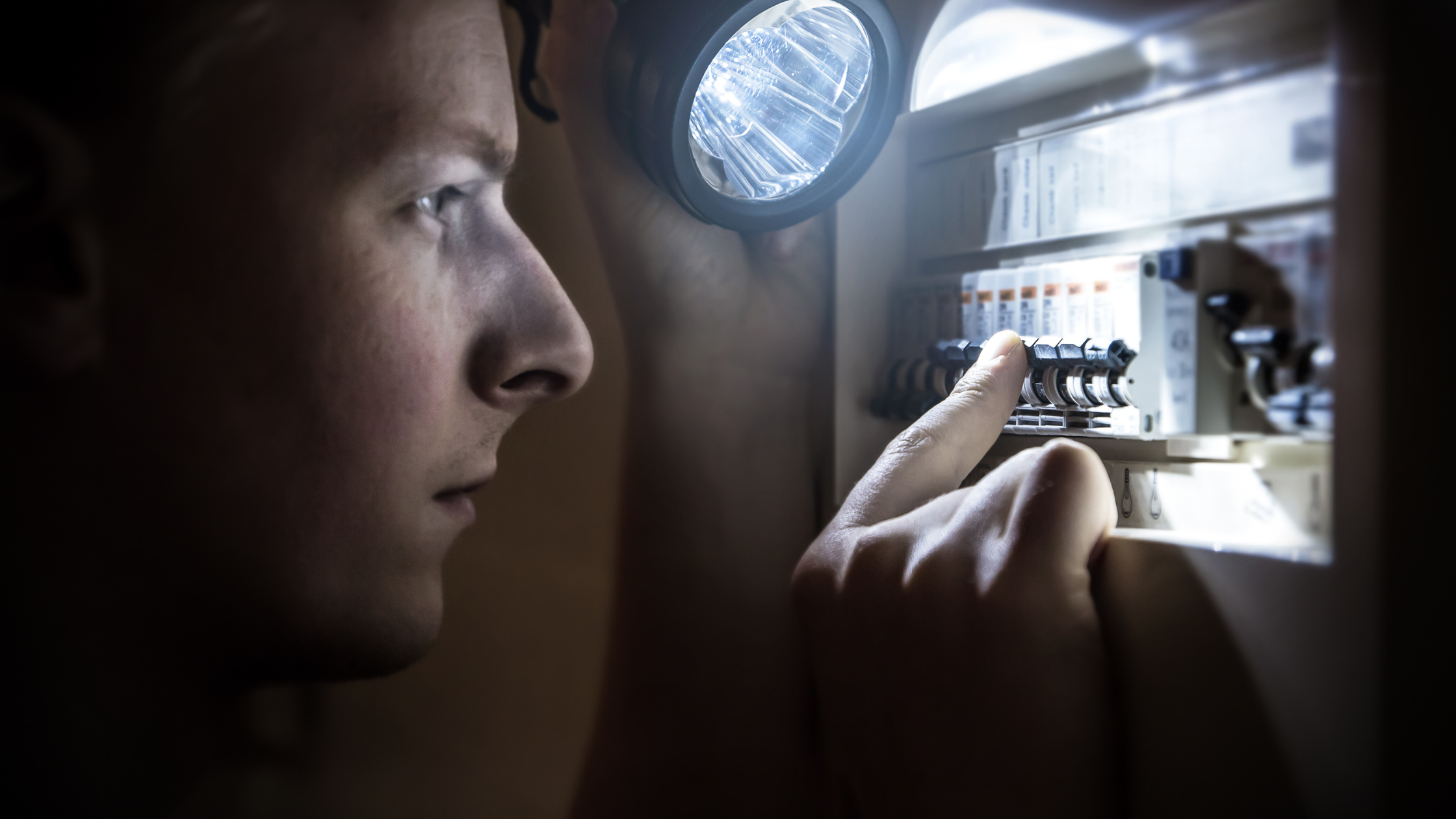 Man checking the distribution board during a power outage